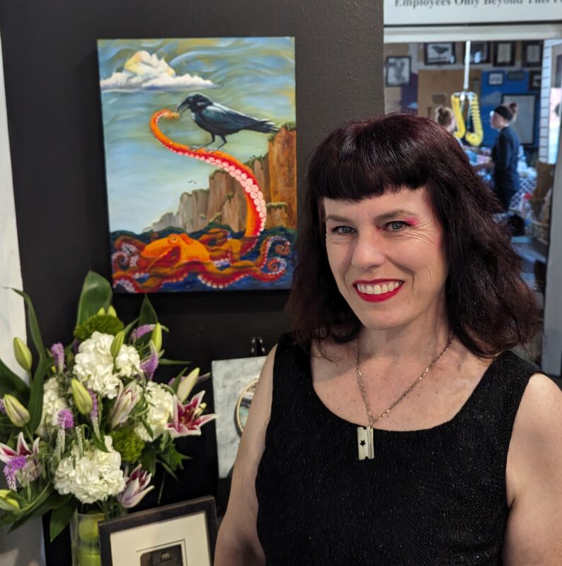 Dawn Pedersen with her oil painting The Offering